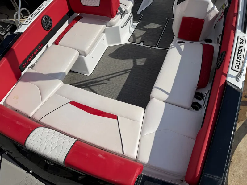 Slide: The Image of Interior of a 2022 Glastron 210 GX boat with red and white seating. - 8