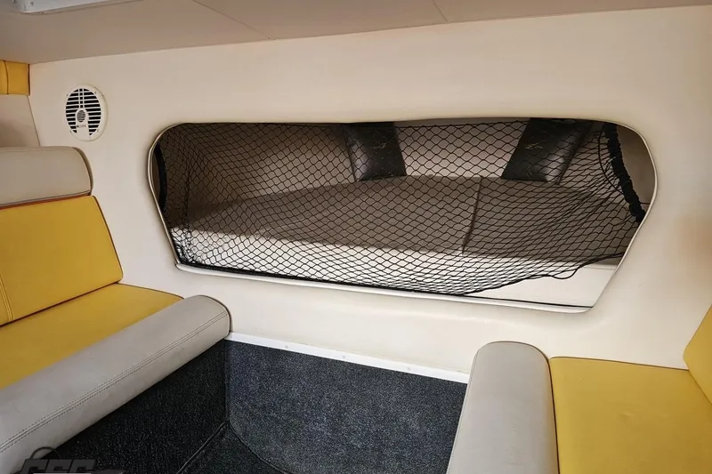 Slide: The Image of Interior of 2007 Donzi 38 ZR boat with yellow seating and netted storage area. - 101