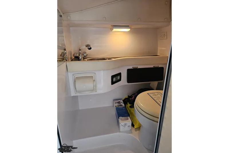 Slide: The Image of 2007 Donzi 38 ZR boat interior bathroom with sink, toilet, and storage. - 105