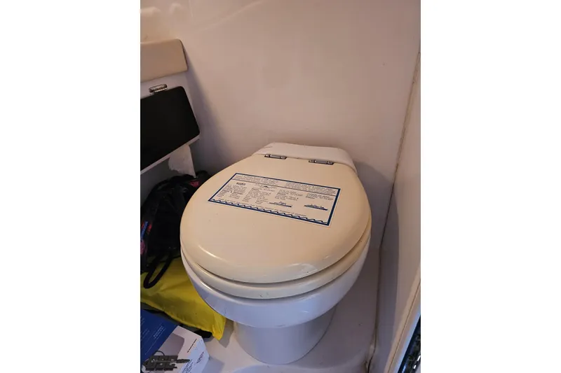 Slide: The Image of 2007 Donzi 38 ZR boat interior with a compact marine toilet. - 107