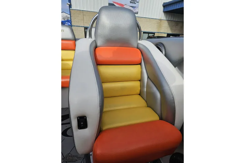 Slide: The Image of 2007 Donzi 38 ZR boat seat with vibrant orange and yellow upholstery. - 114