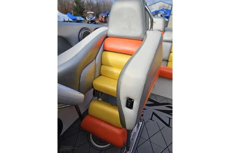Slide: The Image of 2007 Donzi 38 ZR boat seat with orange and yellow upholstery, showcasing sleek design. - 115