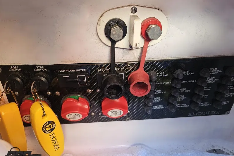 Slide: The Image of Control panel of a 2007 Donzi 38 ZR boat with ignition switches and hour meters. - 120