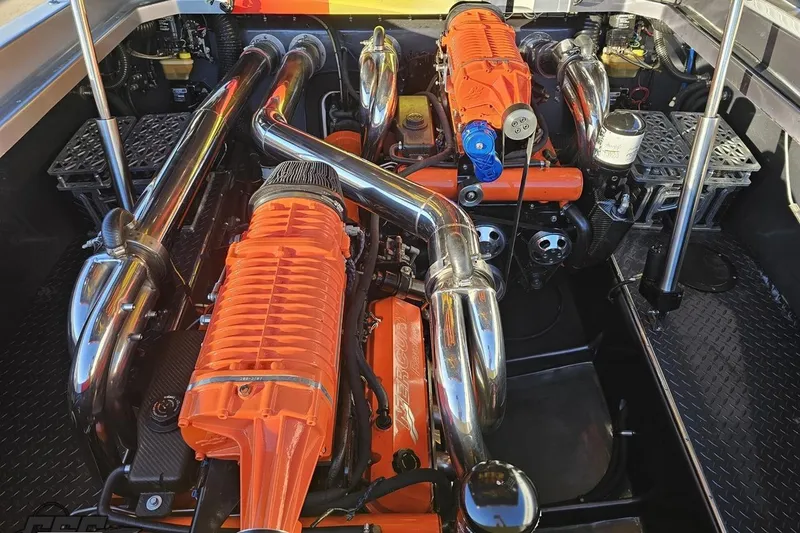 Slide: The Image of Engine compartment of a 2007 Donzi 38 ZR with vibrant orange components and chrome exhausts. - 125
