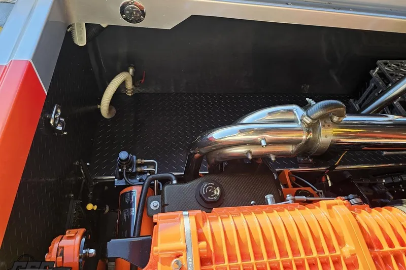 Slide: The Image of Engine compartment of a 2007 Donzi 38 ZR boat, featuring chrome and orange components. - 128