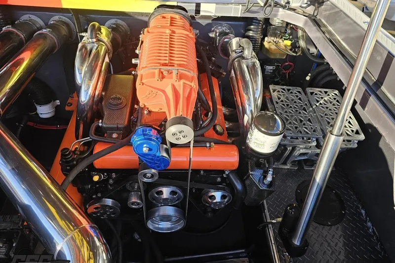 Slide: The Image of Engine of a 2007 Donzi 38 ZR boat with chrome components and orange detailing. - 129