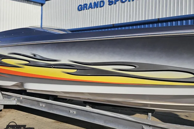 Slide: The Image of 2007 Donzi 38 ZR boat with vibrant flame graphics on trailer. - 13