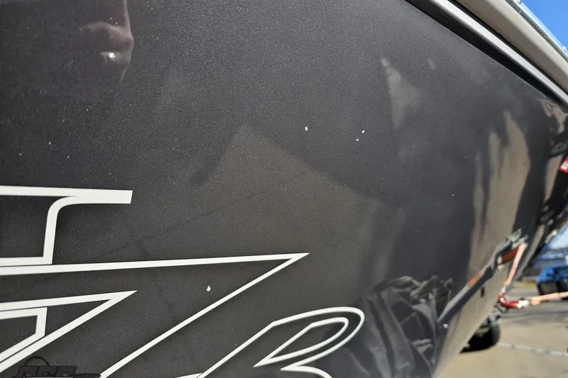 Slide: The Image of 2007 Donzi 38 ZR boat hull with sleek black finish and white lettering. - 15