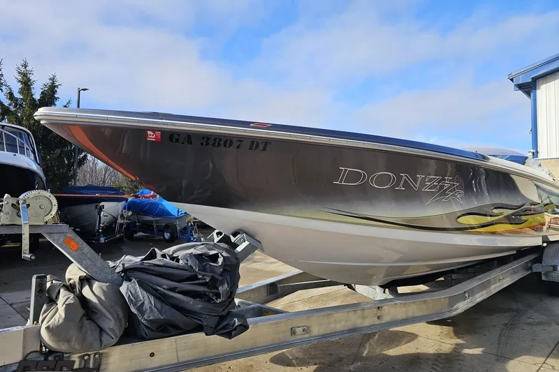 Slide: The Image of 2007 Donzi 38 ZR speedboat on trailer, parked outdoors under blue sky. - 17