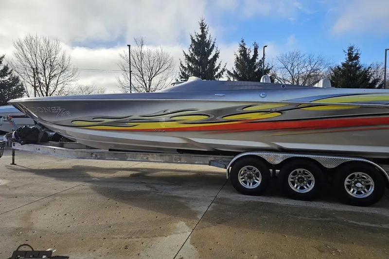 Slide: The Image of 2007 Donzi 38 ZR speedboat with vibrant graphics on a trailer. - 24