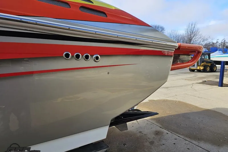 Slide: The Image of 2007 Donzi 38 ZR boat with sleek red and gray design, docked outdoors. - 25