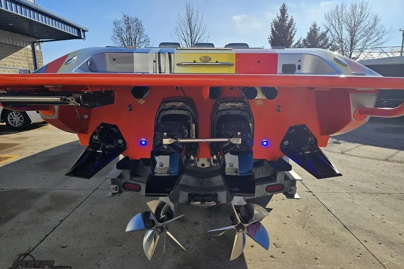 Slide: The Image of 2007 Donzi 38 ZR boat rear view with dual propellers and vibrant orange hull. - 29