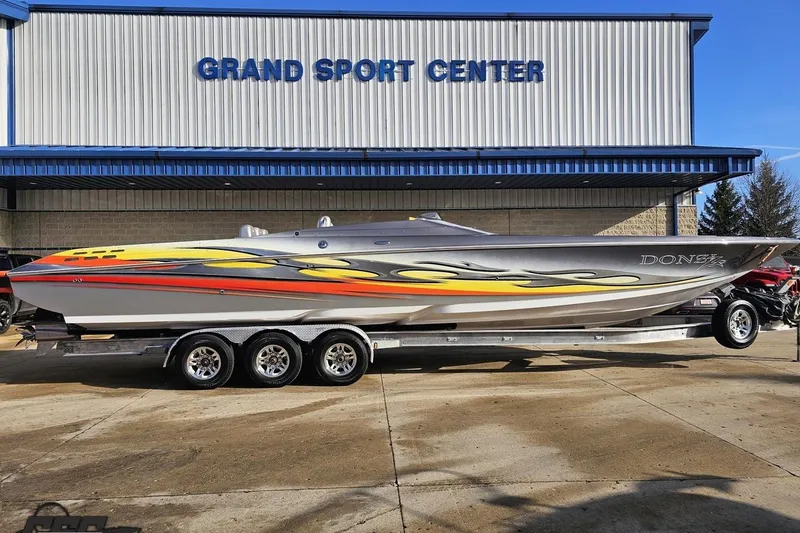 Slide: The Image of 2007 Donzi 38 ZR speedboat with vibrant graphics at Grand Sport Center. - 3