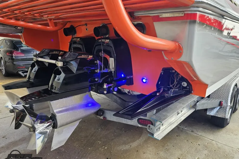 Slide: The Image of Rear view of a 2007 Donzi 38 ZR boat with dual propellers and orange accents. - 32