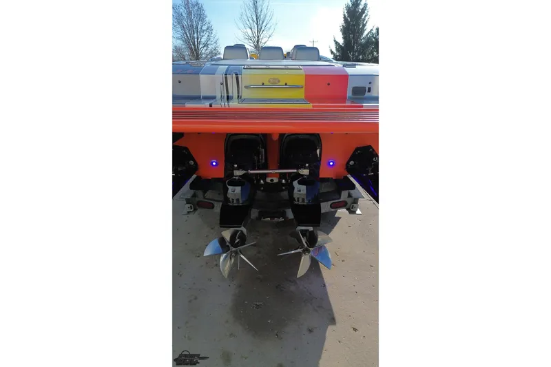 Slide: The Image of 2007 Donzi 38 ZR boat rear view with dual propellers and vibrant color scheme. - 38