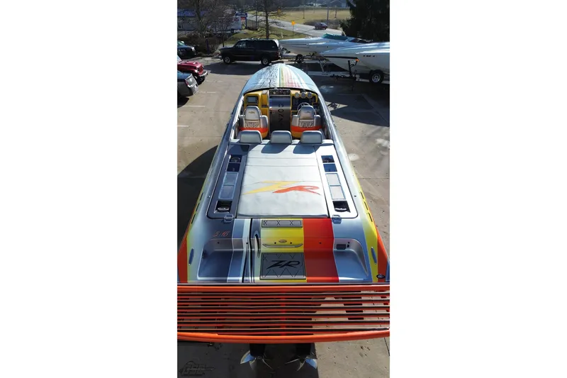 Slide: The Image of 2007 Donzi 38 ZR speedboat with vibrant graphics, docked outdoors. - 39
