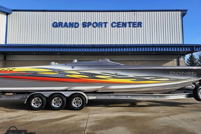 Slide: The Image of 2007 Donzi 38 ZR speedboat with vibrant graphics at Grand Sport Center. - 4