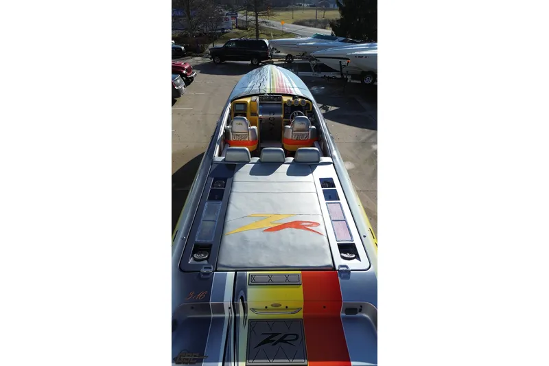 Slide: The Image of 2007 Donzi 38 ZR speedboat with vibrant graphics, parked outdoors. - 40