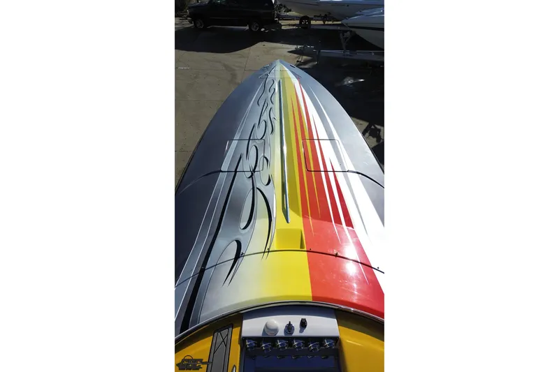 Slide: The Image of 2007 Donzi 38 ZR boat with vibrant red, yellow, and gray graphics on deck. - 45