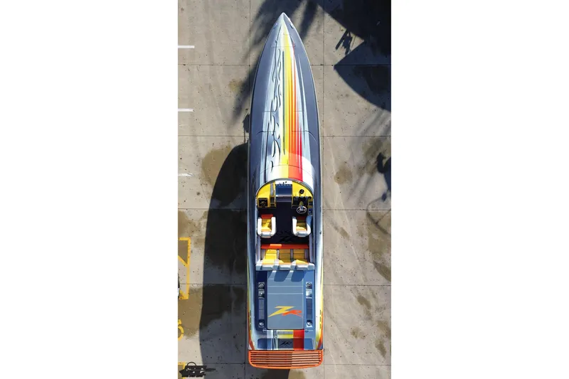 Slide: The Image of Top view of a 2007 Donzi 38 ZR speedboat with colorful stripes on concrete. - 49