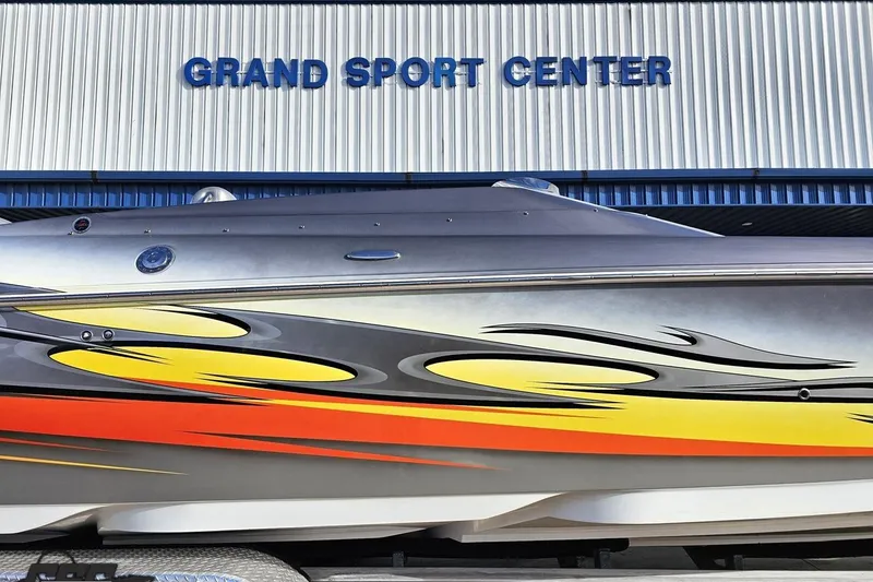 Slide: The Image of 2007 Donzi 38 ZR speedboat with vibrant flame graphics at Grand Sport Center. - 5