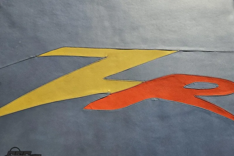 Slide: The Image of 2007 Donzi 38 ZR logo with vibrant yellow and red design on gray background. - 63