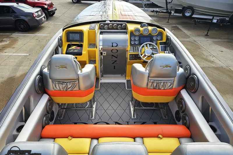Slide: The Image of 2007 Donzi 38 ZR boat interior with vibrant yellow and orange seating, sleek dashboard. - 66
