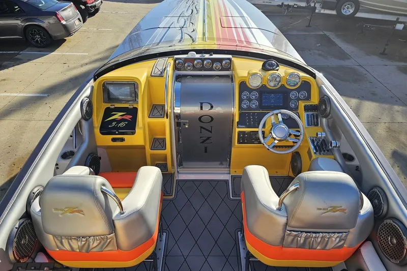 Slide: The Image of 2007 Donzi 38 ZR boat cockpit with vibrant yellow dashboard and dual seats. - 67
