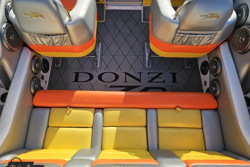 Slide: The Image of 2007 Donzi 38 ZR boat interior with vibrant orange and yellow seating. - 68