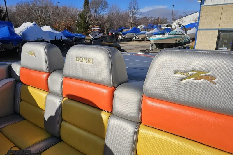 Slide: The Image of 2007 Donzi 38 ZR boat seats with colorful upholstery in a marina setting. - 69