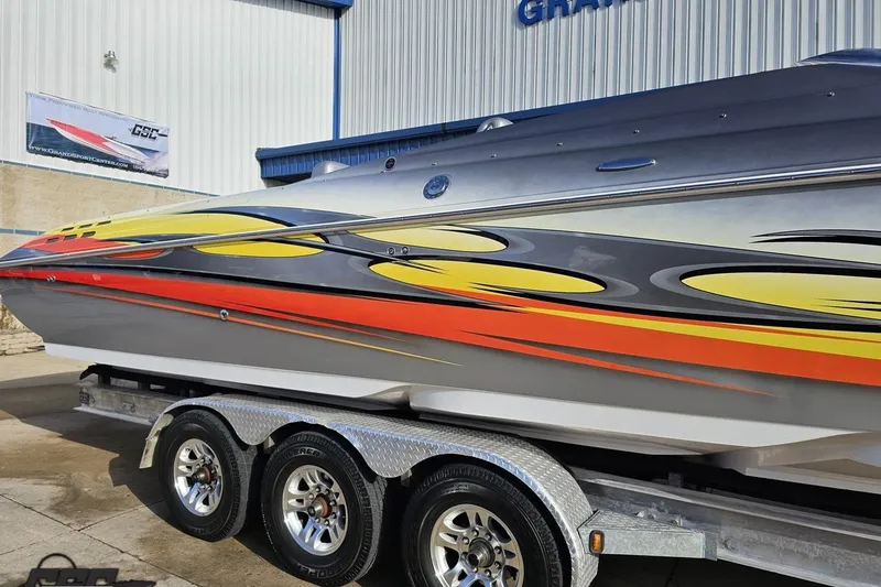 Slide: The Image of 2007 Donzi 38 ZR speedboat with vibrant custom graphics on a trailer. - 7
