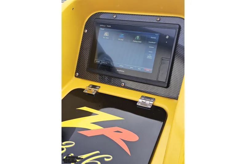 Slide: The Image of 2007 Donzi 38 ZR dashboard with Garmin GPS display and vibrant yellow accents. - 78