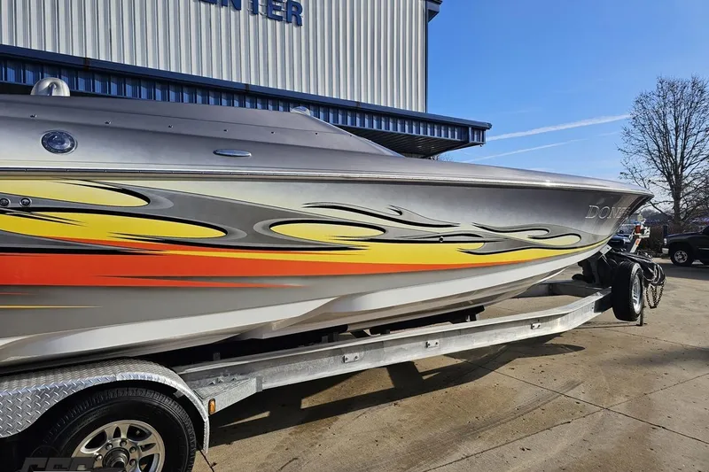 Slide: The Image of 2007 Donzi 38 ZR speedboat with vibrant flame graphics on a trailer. - 8