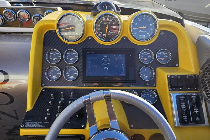 Slide: The Image of Dashboard of a 2007 Donzi 38 ZR boat with gauges and controls. - 82