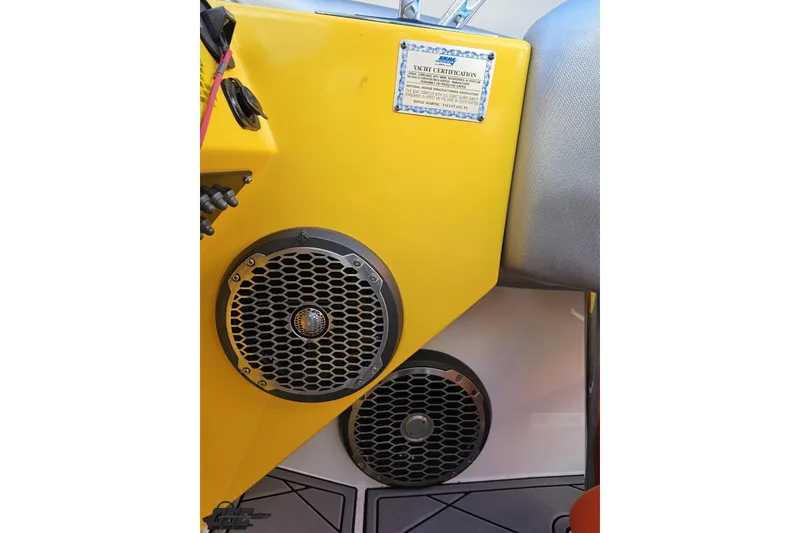 Slide: The Image of Yellow interior of 2007 Donzi 38 ZR boat with speakers and certification plaque. - 87
