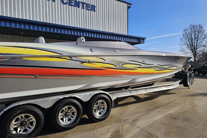 Slide: The Image of 2007 Donzi 38 ZR speedboat with vibrant flame graphics on a trailer. - 9