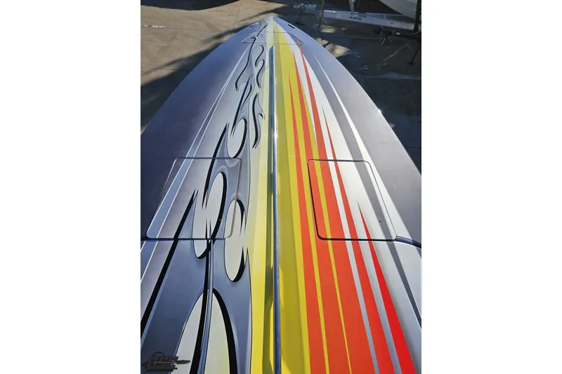 Slide: The Image of 2007 Donzi 38 ZR boat with vibrant flame and stripe design on deck. - 92