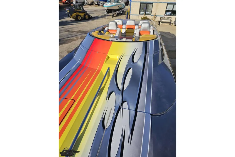 Slide: The Image of 2007 Donzi 38 ZR speedboat with vibrant, colorful graphics and sleek design. - 94