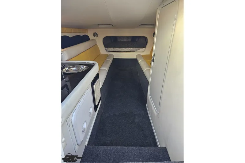 Slide: The Image of 2007 Donzi 38 ZR cabin interior with seating and kitchenette. - 97