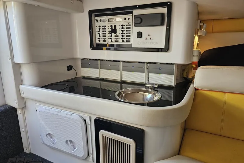 Slide: The Image of 2007 Donzi 38 ZR cabin interior with control panel, sink, and seating. - 99