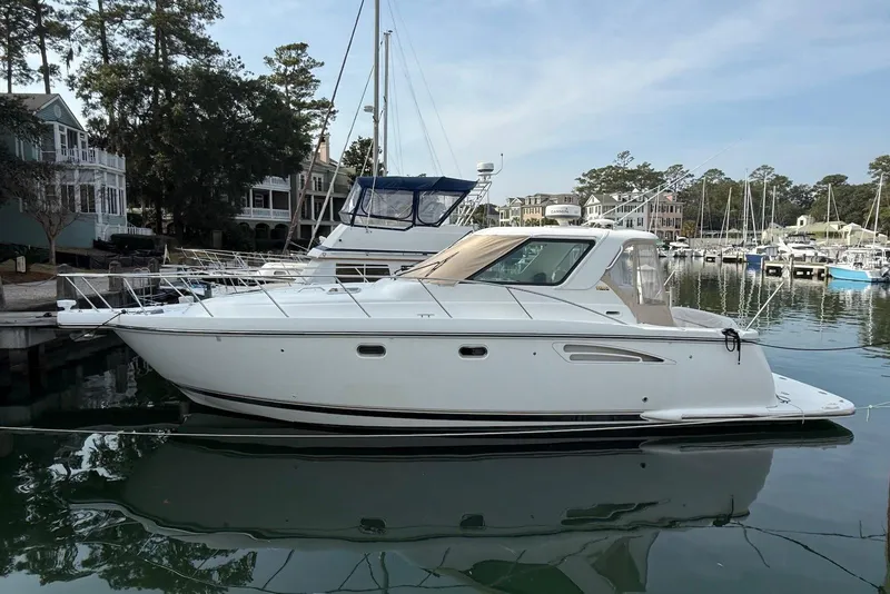 The Image of 2004 Tiara Yachts 3600 Sovran docked in a serene marina setting. - 0