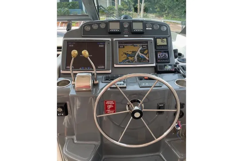 Slide: The Image of Helm of 2004 Tiara Yachts 3600 Sovran with navigation screens and controls. - 10