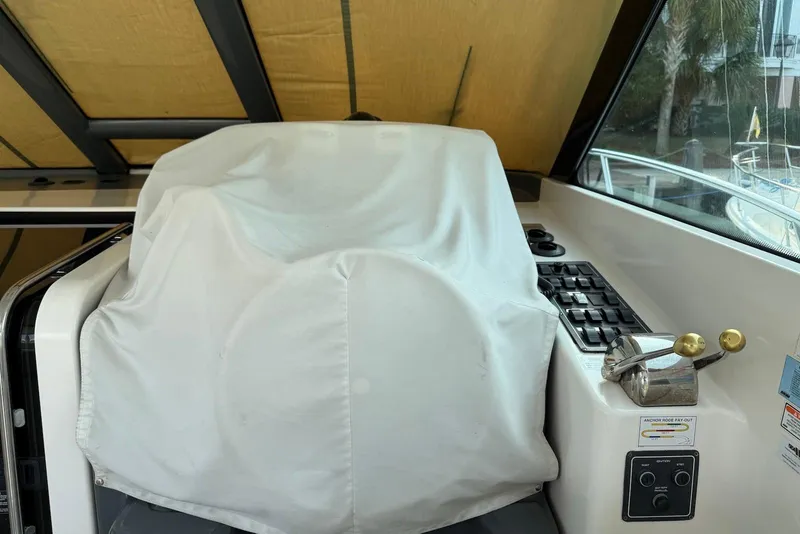 Slide: The Image of Covered helm station of a 2004 Tiara Yachts 3600 Sovran with controls and switches. - 11