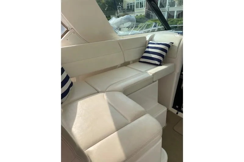 Slide: The Image of 2004 Tiara Yachts 3600 Sovran interior with white seating and striped cushions. - 14