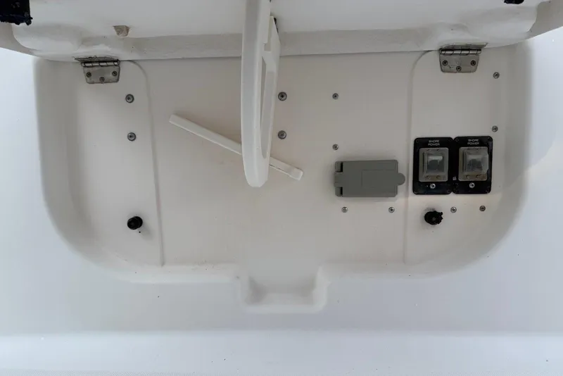 Slide: The Image of 2004 Tiara Yachts 3600 Sovran electrical panel with shore power switches and cover. - 17