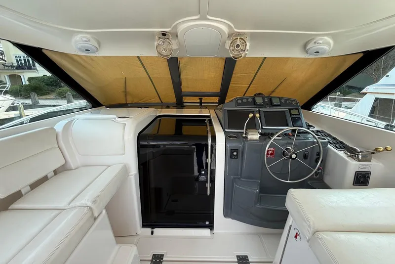 Slide: The Image of 2004 Tiara Yachts 3600 Sovran helm with modern controls and comfortable seating. - 27