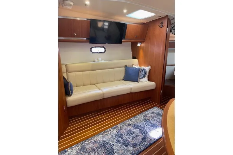 Slide: The Image of Interior of 2004 Tiara Yachts 3600 Sovran with cream sofa, TV, and nautical decor. - 29