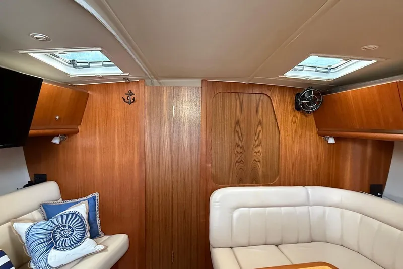 Slide: The Image of Interior of 2004 Tiara Yachts 3600 Sovran with wood paneling and plush seating. - 30