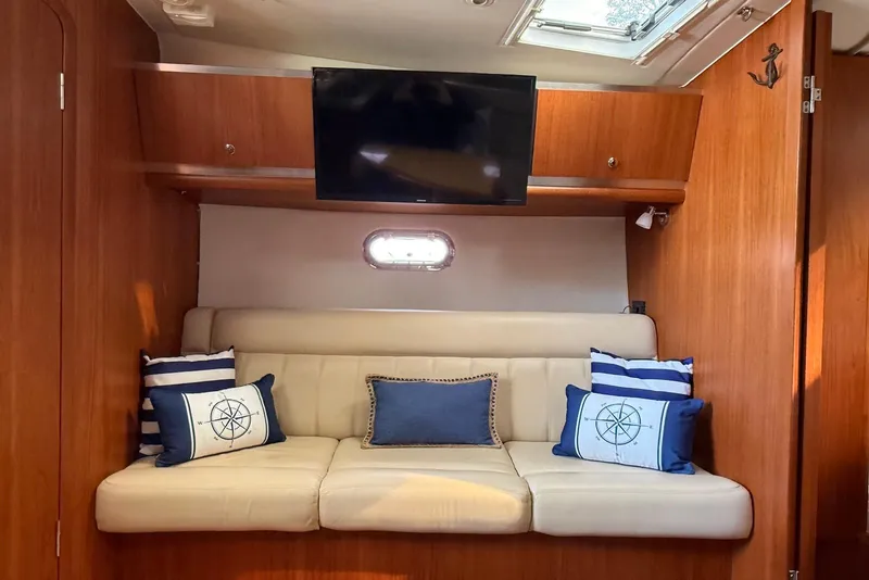 Slide: The Image of Luxurious 2004 Tiara Yachts 3600 Sovran interior with cozy seating and nautical-themed pillows. - 34