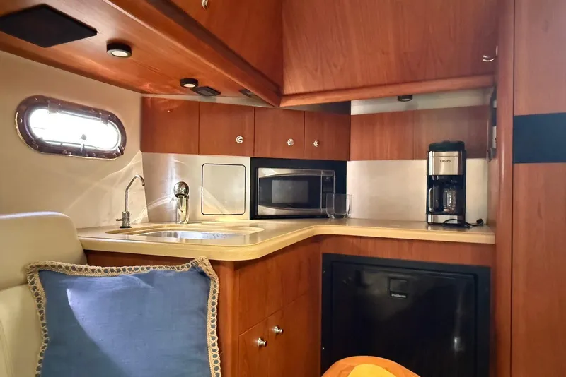 Slide: The Image of 2004 Tiara Yachts 3600 Sovran interior kitchen with sink, microwave, and coffee maker. - 35